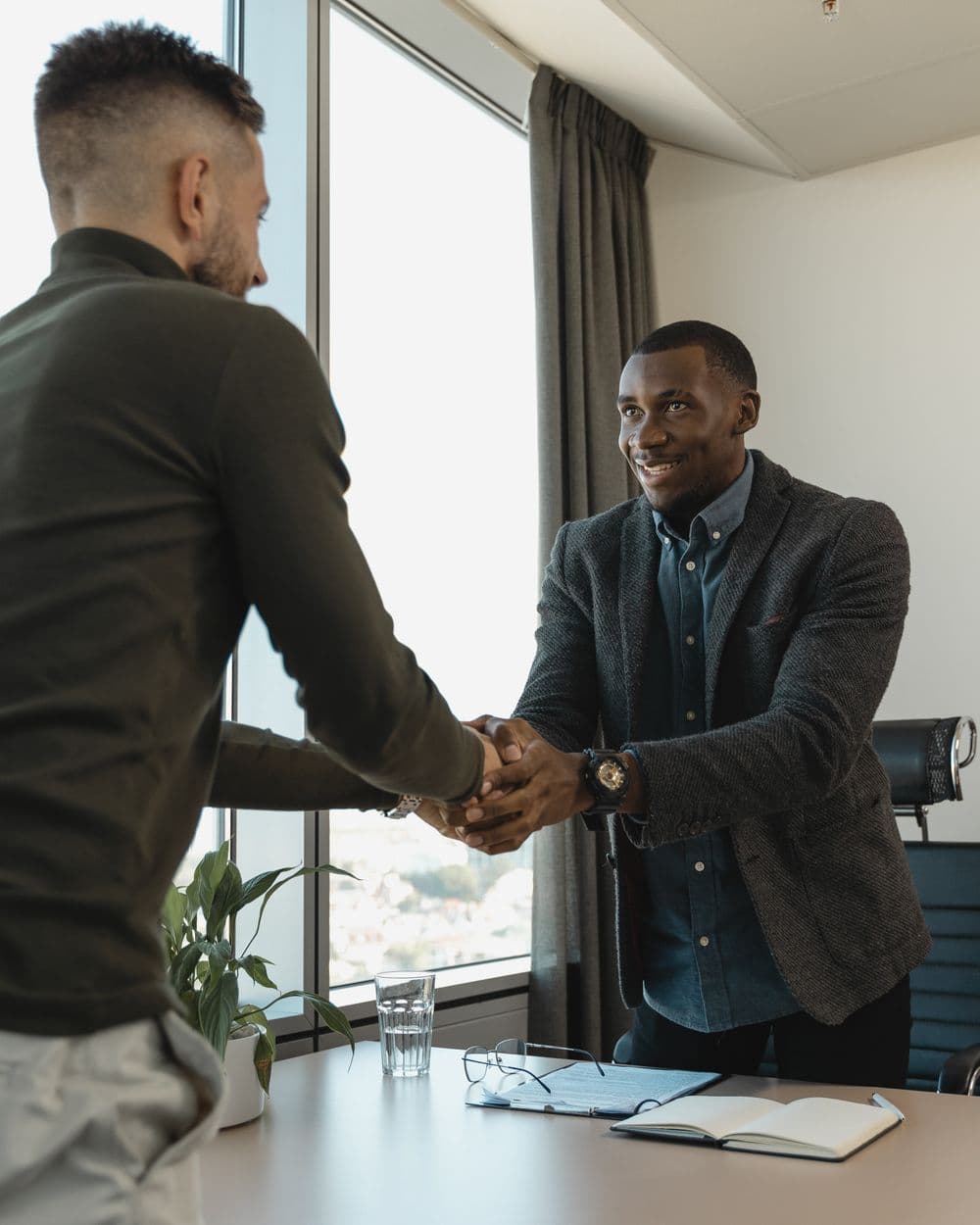 A candidate shaking hands after a successful interview